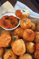Cheese balls with tomato sauce. Fried snack starter meal. Party food