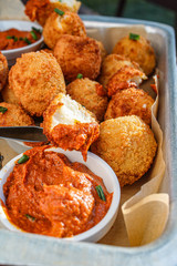 Cheese balls with tomato sauce. Fried snack starter meal. Party food