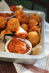 Cheese balls with tomato sauce. Fried snack starter meal. Party food