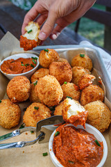 Cheese balls with tomato sauce. Fried snack starter meal. Party food
