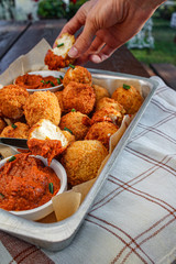 Cheese balls with tomato sauce. Fried snack starter meal. Party food