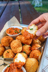 Cheese balls with tomato sauce. Fried snack starter meal. Party food