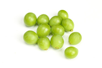 Pile of green unripe grape beans isolated on white background. Organic fruit