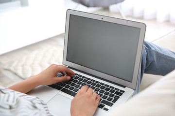 Woman working with modern laptop indoors, closeup. Space for design