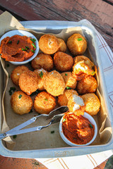 Cheese balls with tomato sauce. Fried snack starter meal. Party food