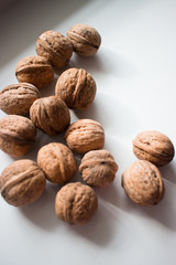 walnuts on a white background in natural sunlight