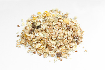 Pile of oat flakes and sweet raisins on white background. Healthy cereal meal