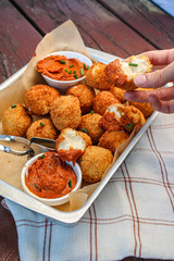 Cheese balls with tomato sauce. Fried snack starter meal. Party food