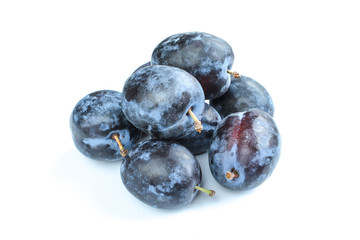 Group of organic plums isolated on white background