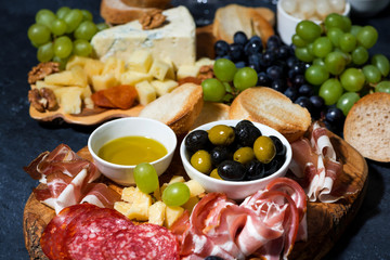 cold cuts, bread and cheese on wooden board