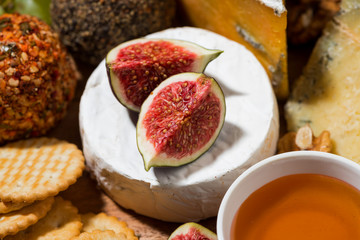 delicious snacks, cheese, crackers and fresh fruits, closeup