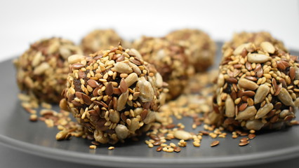 Vegan sweets made from dried fruits and sesame seeds, flax and sunflower seeds