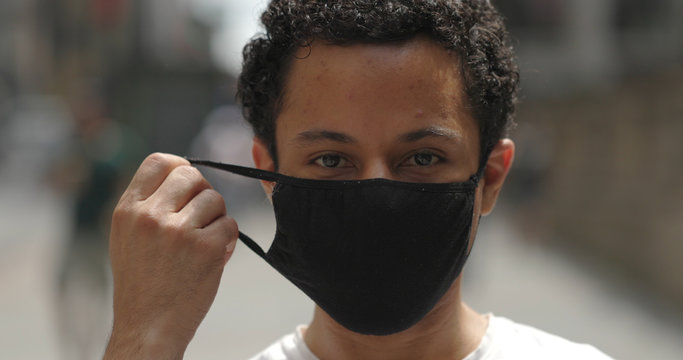 Young Hispanic Man In City Face Portrait Wearing Mask