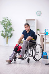 Young leg injured contractor in wheel-chair cleaning the house