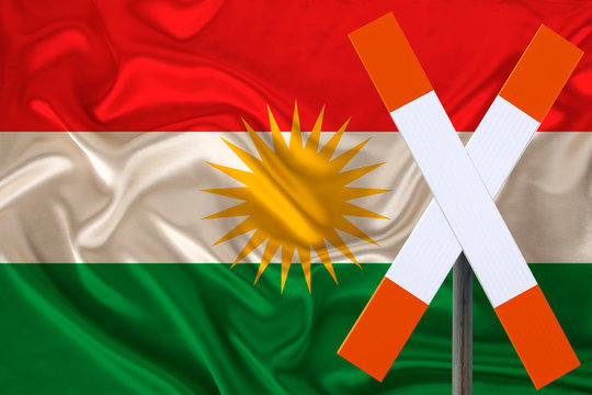 sign, stop, attention against the background of the silk national flag of Kurdistan, rojava, the concept of border and customs control, violation of the state border, tourism restrictions
