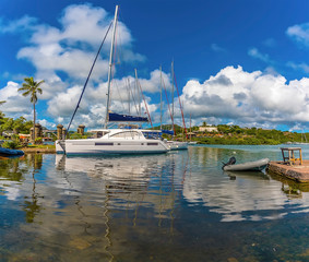 Fototapeta na wymiar Reflections of boats moored in the English Harbour in Antigua