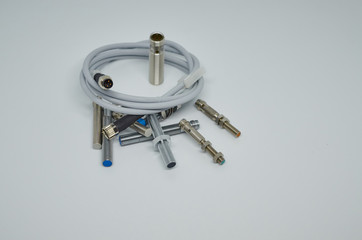 Many Inductive proximity sensor or proximity switch on a white background.