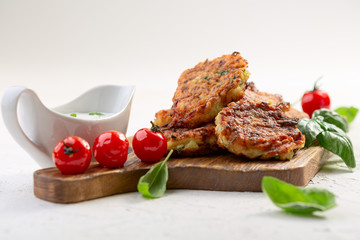Zucchini fritters with yogurt sauce. Vegetarian cuisine.