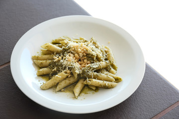 Delicious penne pasta with pesto sauce on plate