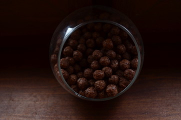 Breakfast. Chocolate balls from cocoa in a beautiful transparent glass on a dark background.