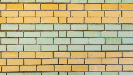 horizontal wall of yellow and green bricks, backgrounds, textures