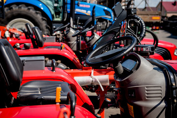 Rows of modern tractors. Industrial details. Agricultural 