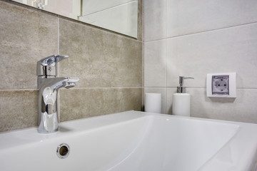 water tap sink with faucet in expensive loft bathroom or kitchen.