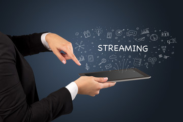 Close-up of a touchscreen with STREAMING inscription, social media concept