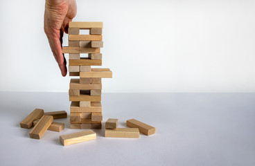 Wood block tower with architecture model. Concept Risk of management and strategy plan, growth...