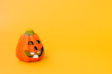 Halloween pumpkin. Scary pumpkin on a yellow background.