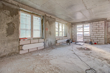 Unfinished construction empty room. Walls from lightweight aggregate concrete blocks with empty...