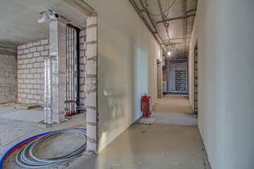 Unfinished construction empty room. Walls from lightweight aggregate concrete blocks with empty...