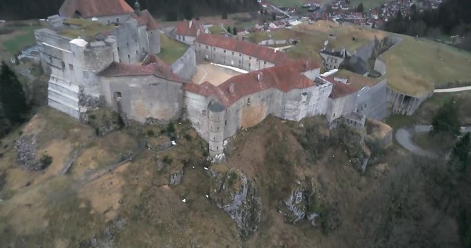 Aerial medieval fortification around a tophill joux castle in jura mountains