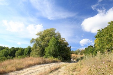 Dirt road in the field and clouds in the vicinity of the village of Avren (Bulgaria)