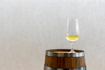 iso crystal bowl with cachaça in wooden barrel.