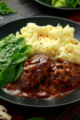 Salisbury Steak with mushroom gravy, mashed potatoes and spinach