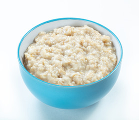 oatmeal  in blue ceramic bowl isolated white background