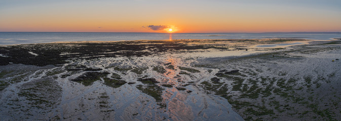 Naklejka premium Luc Sur Mer, France - 08 04 2020: Sunrise over Le Havre from the beach