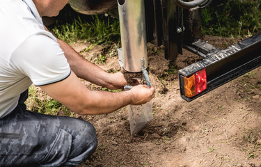 Soil examination. Collecting black soil on the field for examination