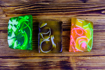 Pieces of the handmade soap on wooden background. Top view
