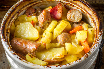 Irish coddle stew with sausage, bacon, potatoes, carrots and onions served in a casserole dish.