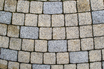 Pavers laid out in a semicircle. Paving squares and rectangles are laid out on the surface.