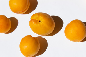 fresh bright yellow garden summer apricot fruit on white background vegan food healthy diet concept