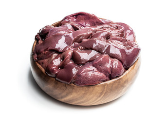 Raw pork liver in wooden bowl isolated on white