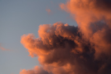 Dramatic sunset sky with pink clouds after the storm. Colorful cloud closeup