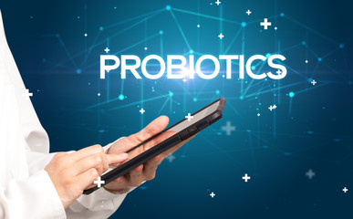 Doctor fills out medical record with PROBIOTICS inscription, medical concept
