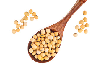 Organic raw soybeans in wooden spoon isolated on white background. Top view with copy space and text.
