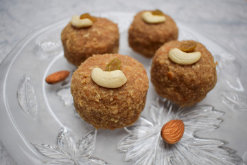 Prashad ladoos garnished with fry fruits for Ganesh chaturthi festival in India. Wish happy ganesh chaturti with sweet dish tasty laddus
