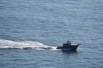 Small boat speeds along near the shore.