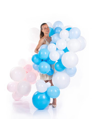 A girl in a white dress with balloons poses on a white background.